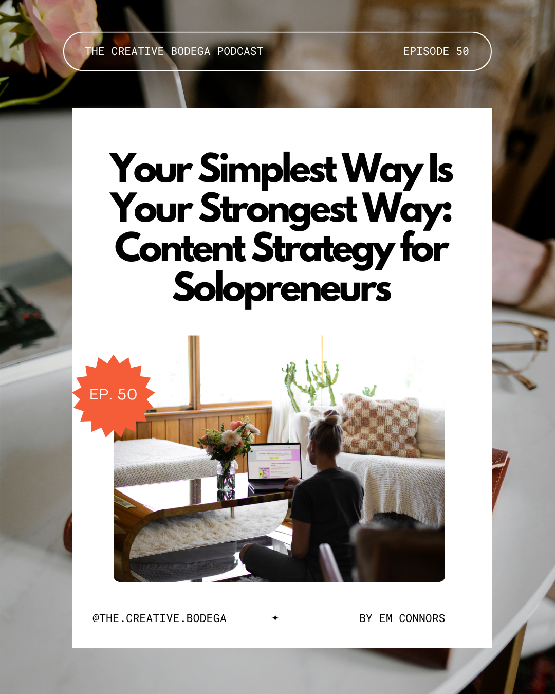 Em sitting looking at her laptop in an art deco living room